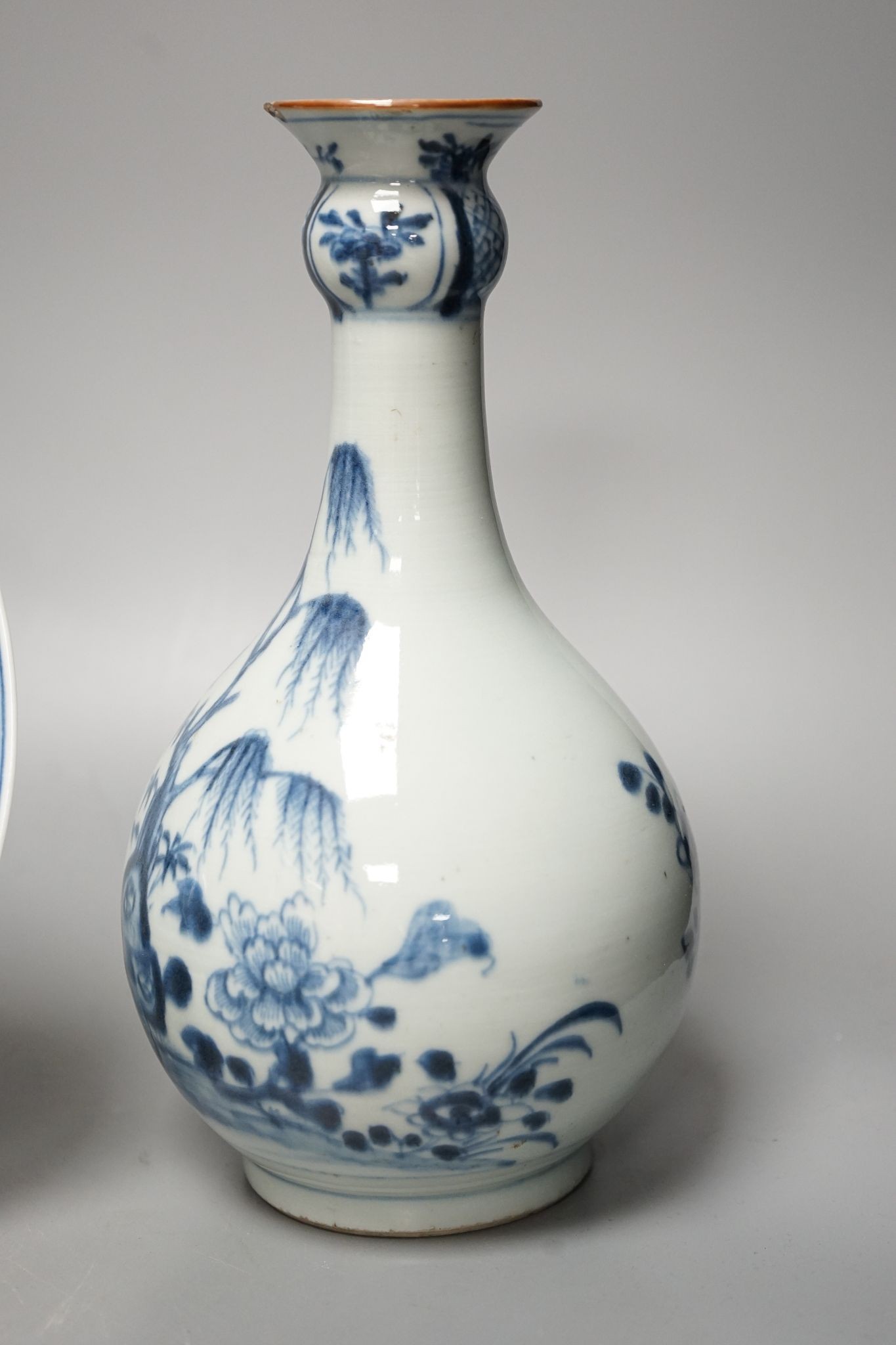 An 18th century Chinese blue and white bottle vase and two 19th century blue and white plates, diameter of largest plate - 25cm
